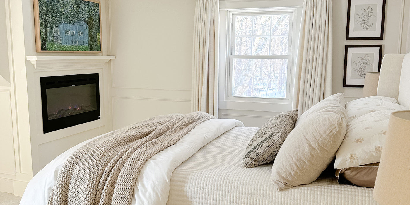 36-inch wide Touchstone Sideline® 36 Smart Electric Fireplace accent wall maximizes space in a small, neutral styled bedroom by @sweetboochie