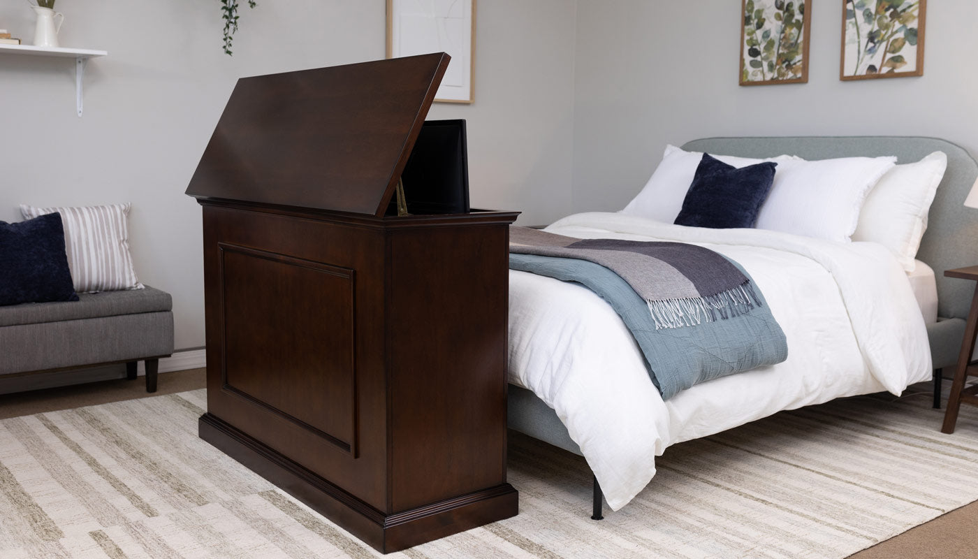 Touchstone Elevate TV Lift Cabinet in dark brown Espresso wood finish raised half way at the end of the bed
