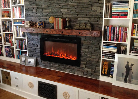 Touchstone Sideline 36 Electric Fireplace recessed in stone wall with built in bookcases