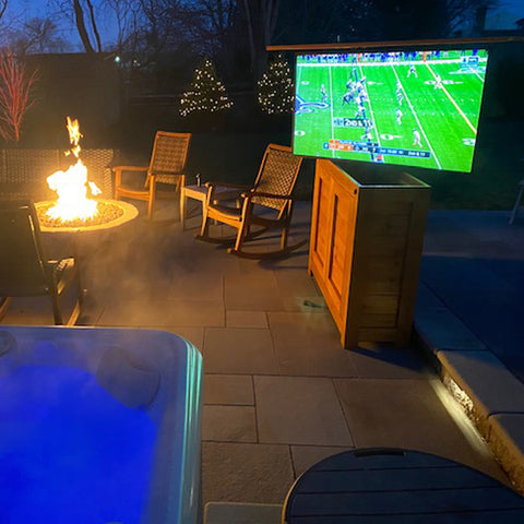 Touchstone TV Lift Pro with 360 degree swivel in an outdoor TV lift cabinet by the pool
