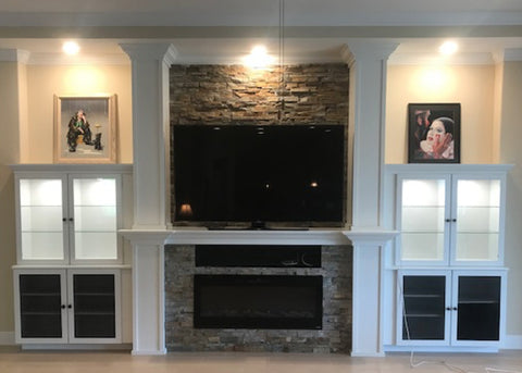 Touchstone Sideline Electric Fireplace in white mantel with stone and built in shelving by JMAP Homes