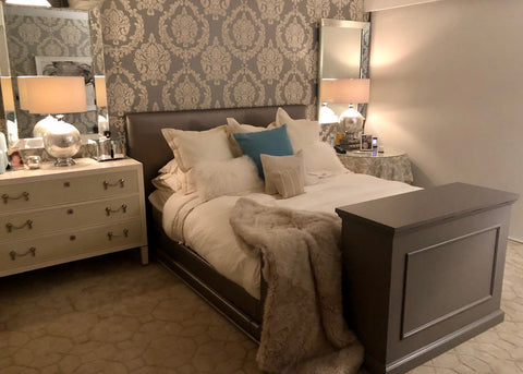 Touchstone Elevate Espresso TV Lift Cabinet in a bedroom with leather headboard and neutral color accents