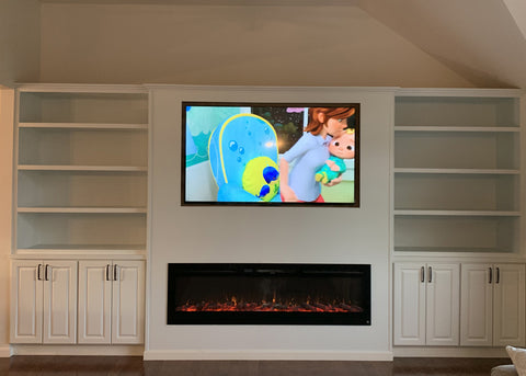 Touchstone Sideline 72 Electric Fireplace recessed into built in cabinets.