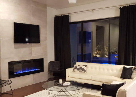 Modern white living room accented with the blue flames of the Touchstone Sideline 60 Electric Fireplace