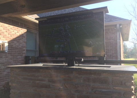 Whisper Lift TV Lift Mechanism installed in an outside brick enclosure