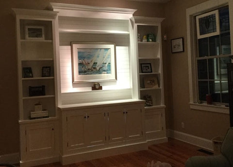 Custom built bookcase featuring the Touchstone Whisper Lift II TV Lift