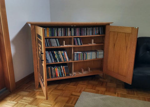 Whisper Lift TV Lift installed in custom cabinet with media shelf