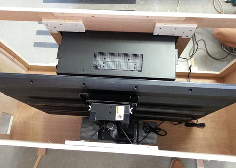 Whisper Lift TV Lift  inside a cabinet in an TV