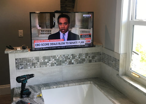 The Touchstone SlimLift Pro fits nicely in the tiled half wall for TV viewing from the bath.