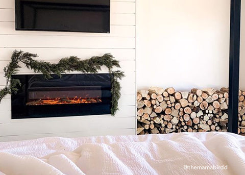 Touchstone Electric Fireplace with holiday cheer in a bedroom