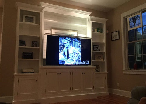 Hidden TV lift in a custom built bookcase
