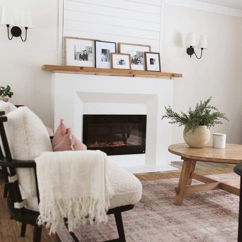 Touchstone Sideline 36 Electric Fireplace in angled surround mantel with light wood topper by @ourhighlandshome