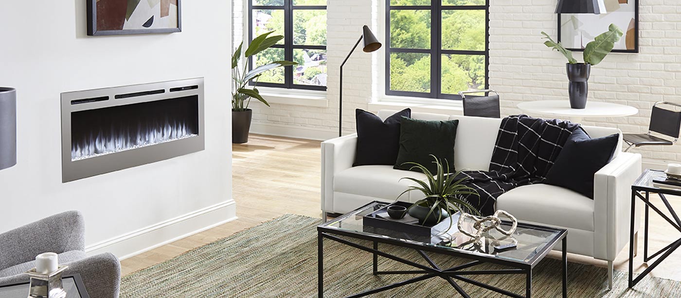 Touchstone Sideline Stainless Steel Electric Fireplace in modern living room with black frame windows