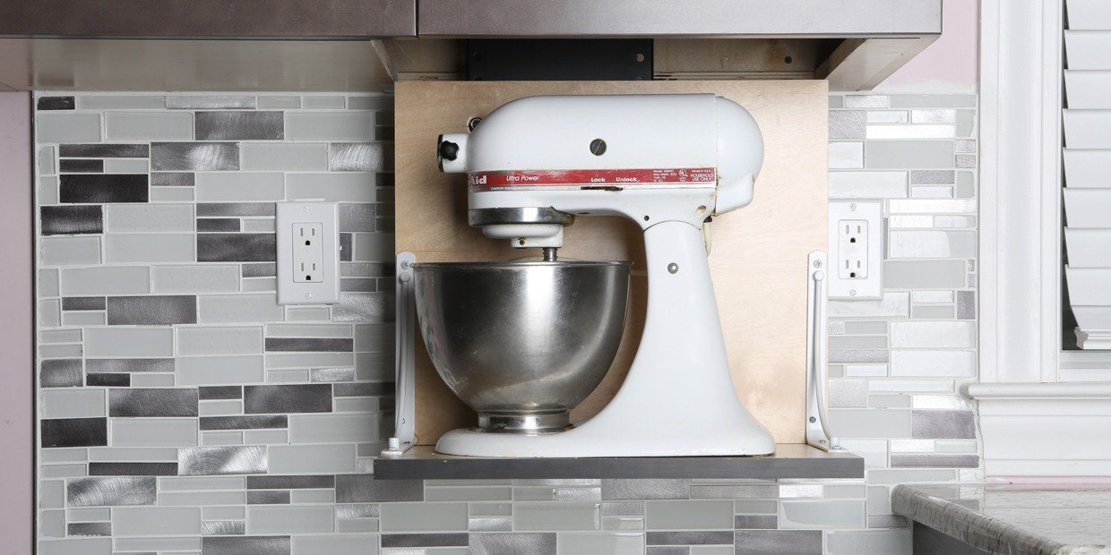 The Touchstone WhisperLift II motorized lift raises and lowers a heavy Kitchanaid® mixer in the cabinet. 