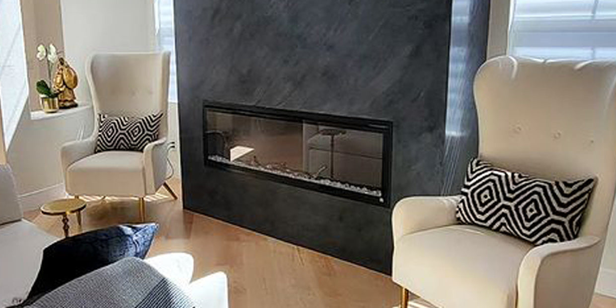 18 foot tall fireplace accent wall with hand applied black venetian plaster featuring Touchstone Sideline Elite Smart Electric Fireplace, room design by Hermogeno Designs, California
