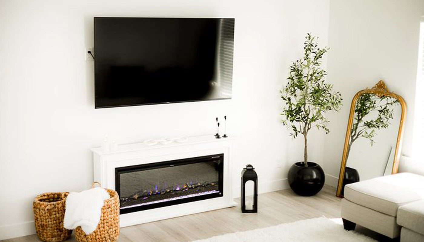 Touchstone Encase Freestanding Mantel with Touchstone Sideline Elite Smart Electric Fireplace in white living room with TV mounted above photo credit: @karinabbingham
