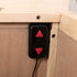 Touchstone Elevate 72009 TV Lift remote control pictured inside the cabinet. 