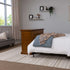Touchstone Elevate 72009 TV Lift Cabinet in Honey Oak wood finish pictured from an angle in a bedroom. 