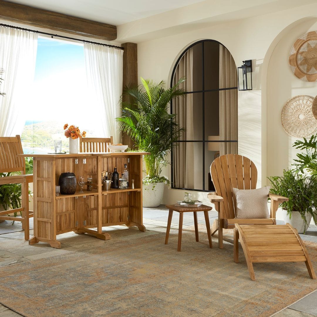 Touchstone Ayenya Teak Adirondack chair lifestyle photo showing the chair with the Bar Set.