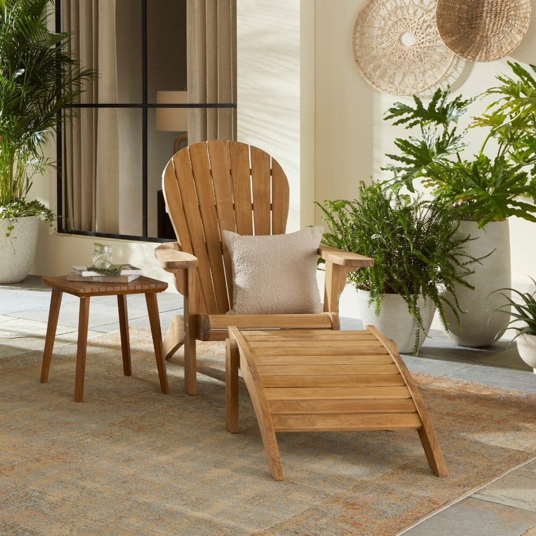 Touchstone Ayenya Teak Adirondack chair lifestyle photo from a front angle.