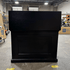 Black Elevate TV Lift Cabinet showroom unit photographed in the warehouse.