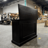 Black Elevate TV Lift Cabinet showroom unit photographed in the warehouse.