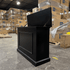 Black Elevate TV Lift Cabinet showroom unit photographed in the warehouse.