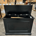 Black Elevate TV Lift Cabinet showroom unit photographed in the warehouse.