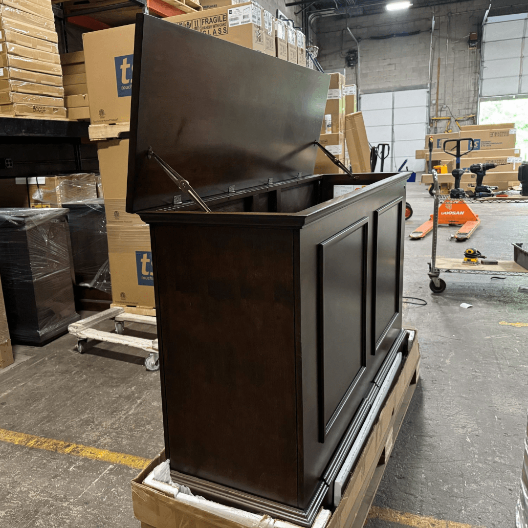 Grand Elevate open box tv lift cabinet photographed in the warehouse.
