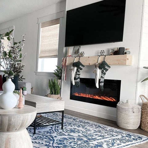 Touchstone Sideline Electric Fireplace with light wood mantel and white wall by @homewithyates