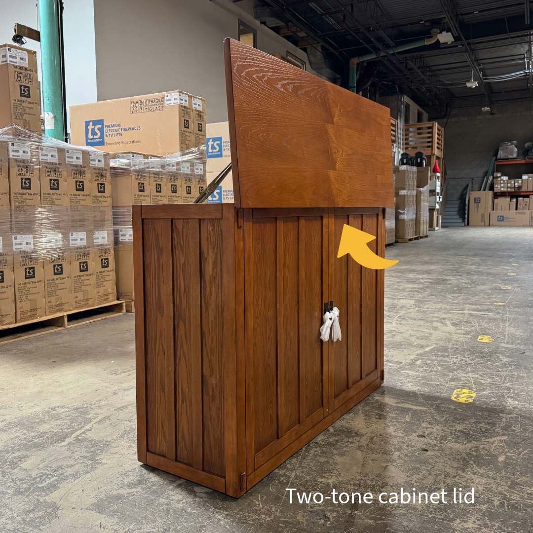 Touchstone Elevate Mission Smart TV Lift Cabinet in a light oak finish photographed in the warehouse - showroom unit.