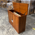 Touchstone Elevate Mission Smart TV Lift Cabinet in a light oak finish photographed in the warehouse - showroom unit.