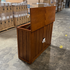 Touchstone Elevate Mission Smart TV Lift Cabinet in a light oak finish photographed in the warehouse - showroom unit.