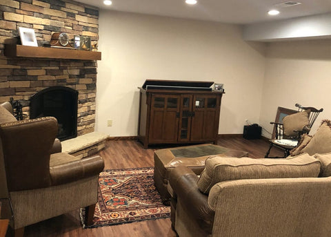 Touchstone Bungalow TV Lift Cabinet in a family room with stone fireplace