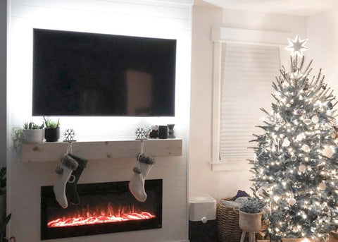 Touchstone Sideline Electric Fireplace with white mantel and Christmas tree