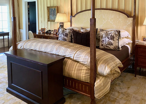 Touchstone Mini Elevate TV Lift Cabinet in espresso wood finish, placed at the ed of the bed