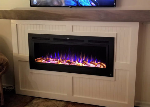 Touchstone Sideline Steel Electric Fireplace with steel grate front and premium LED flames add a realistic look to the faux fireplace.