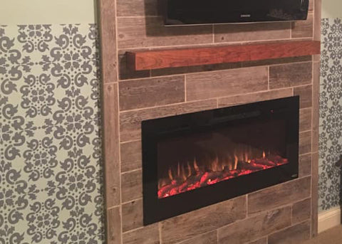 Touchstone Sideline Elite Electric Fireplace with faux wood paneled mantel and geometric wallpaper