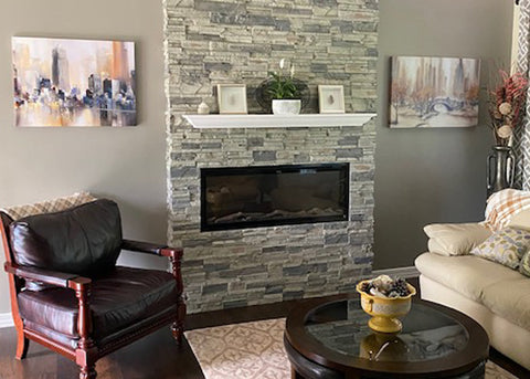 Touchstone Sideline Elite Electric Fireplace with faux stone and white mantel.