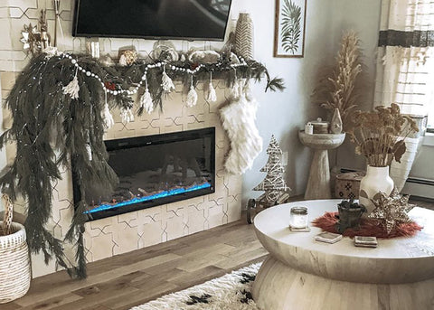 Sideline Elite Electric Fireplace with blue and yellow flame and holiday greenery