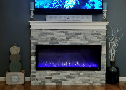 Touchstone Sideline Elite electric fireplace with white and gray brick mantel showing blue and orange flame display