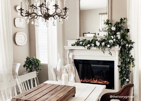 Touchstone Electric Fireplace with beautiful mantel and garland by @theivorygrove