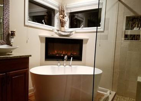 Touchstone Sideline 36 Electric Fireplace in the bathroom behind the soaking tub