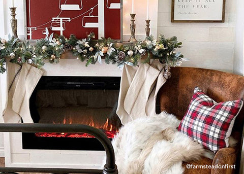 Touchstone Forte Electric Fireplace decorated for the holidays with white stockings