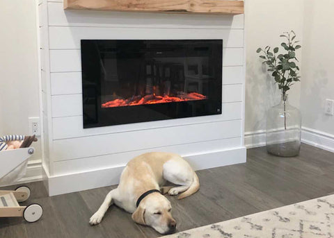 Touchstone Sideline Electric Fireplace with white shiplap and reclaimed wood mantel and lab