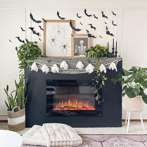 Halloween decor with Touchstone Forte Electric Fireplace in black half wall by @the.modberry