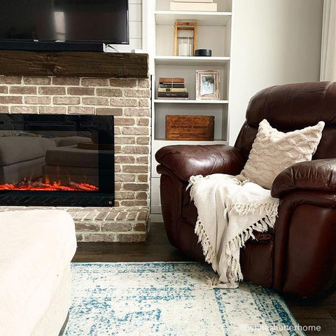Touchstone Forte Electric Fireplace in brick fireplace with dark wood mantel