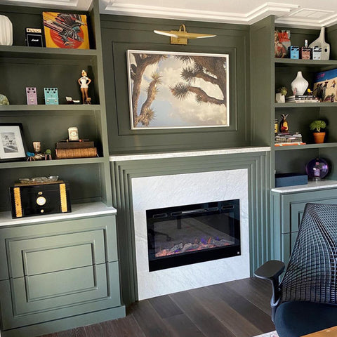 Touchstone Sideline Electric Fireplace in a home office built in shelving in green paint by dasia.does.it
