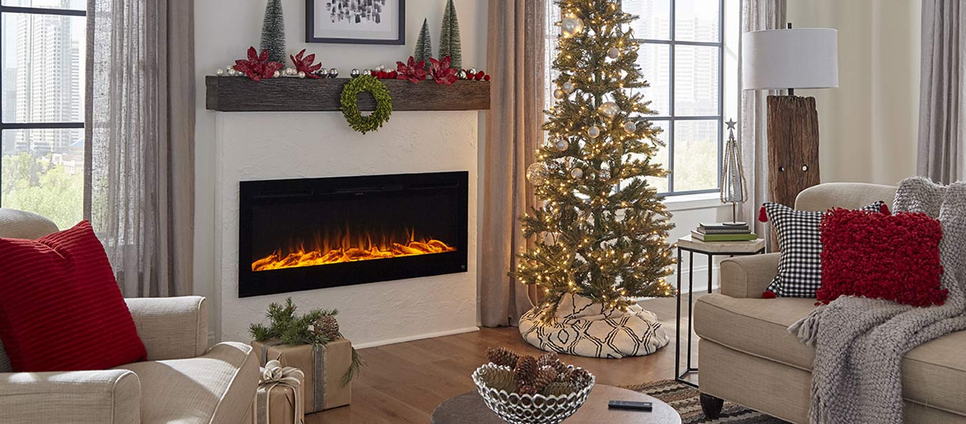 Touchstone Sideline Smart Electric Fireplace is inserted in a white accent wall and decorated for the holidays.