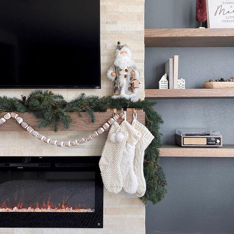 Touchstone Sideline Electric Fireplace in stone wall with blue gray surround decorated for the holidays by @athomewithemilyjean